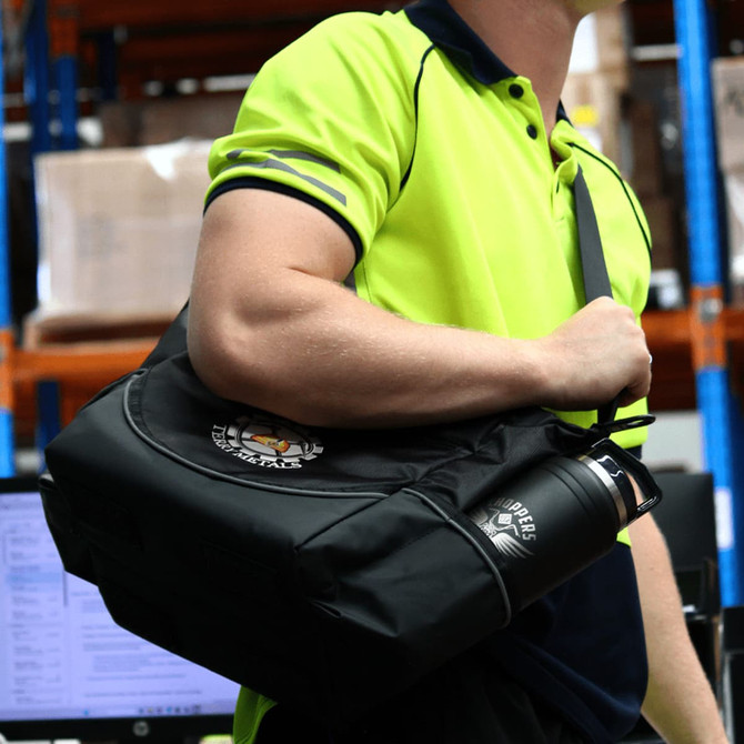 A black duffel bag and drink bottle held by a person in a high-visibility yellow shirt, with a logo visible.