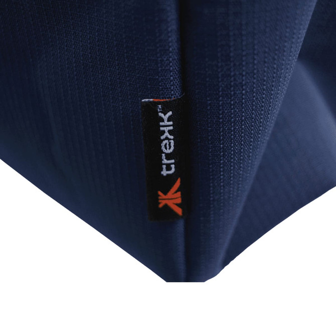 A close-up of a navy blue waterproof beach bag, featuring a small branded tab.