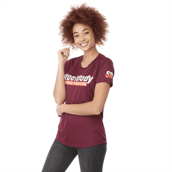 A maroon women's short sleeve tech tee with a logo on the sleeve and text on the front.
