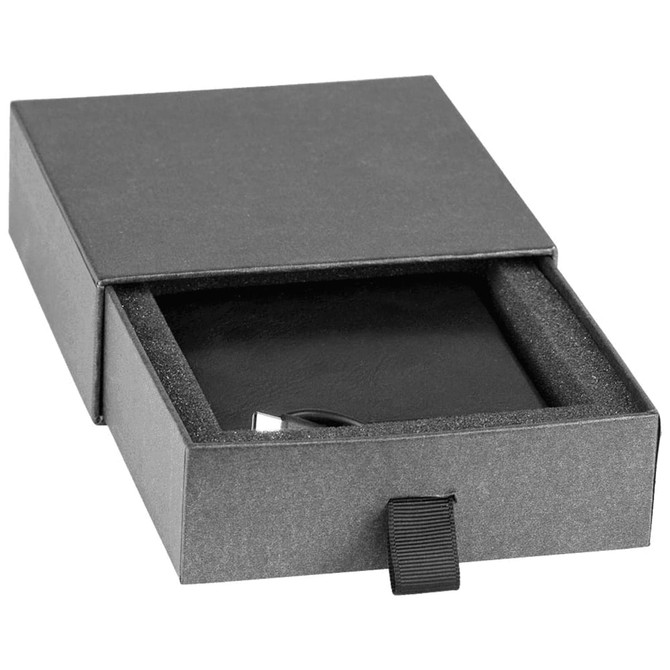 A black box containing a wireless charger with a sleek design and cushioning inside. Includes branding.