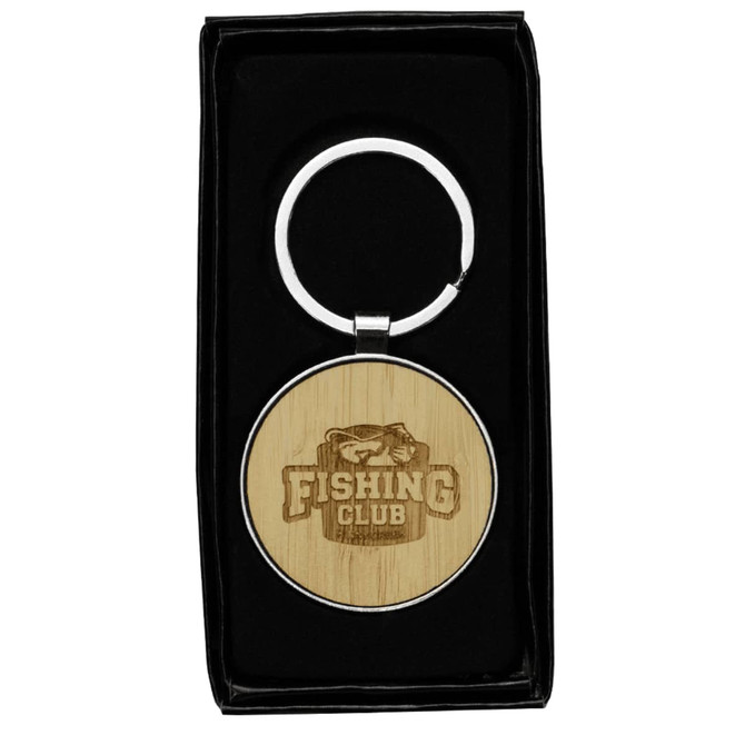 A circular keyring made of recycled zinc alloy with a bamboo disc, presented in a black box.