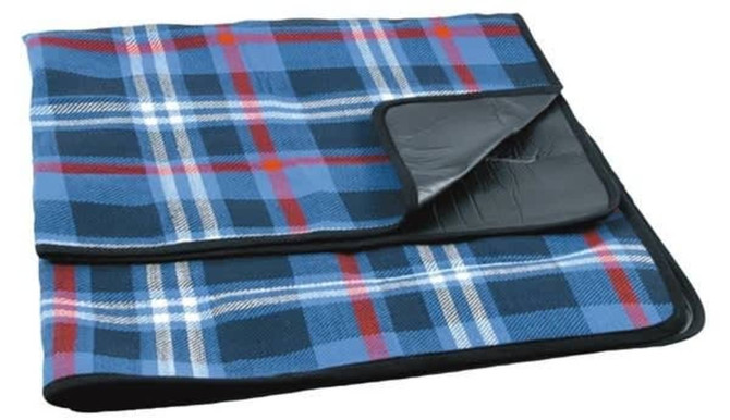 A blue and red checkered picnic rug with a black backing, featuring a fold-over edge and a logo.