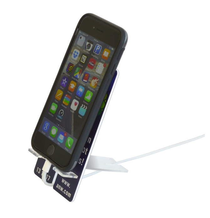 A phone stand in white, holding a black smartphone, with a display for apps visible on the screen.