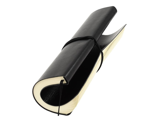 A black notebook with a curved design, featuring a black elastic closure and cream-coloured pages.