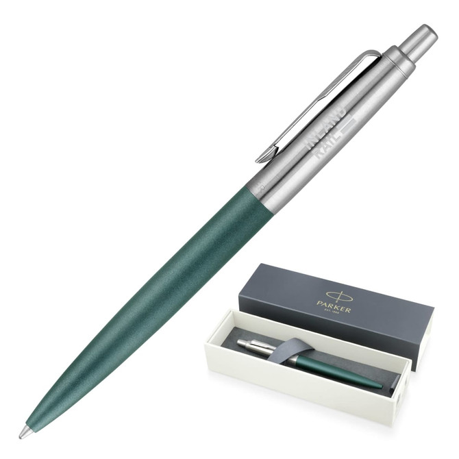 A ballpoint pen in matte green with a metal finish, displayed in a stylish box with branding.