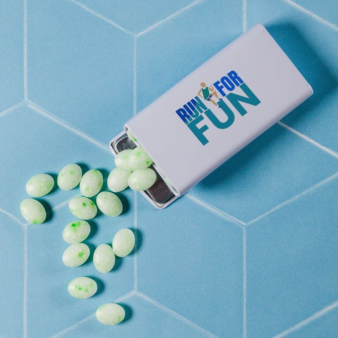 A flip top tin of Spearmints, 25g, with mints spilled out, featuring a promotional design that reads "RUN FOR FUN."