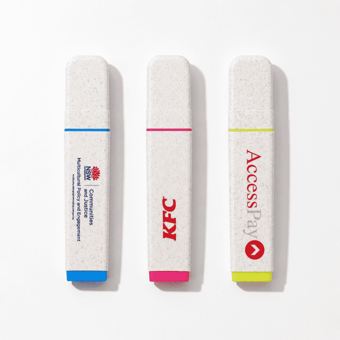 Three highlighters in biodegradable casing: blue, pink, and yellow, featuring various logos.