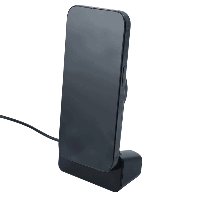 A sleek black wireless charger with a stand, holding a smartphone in an upright position.