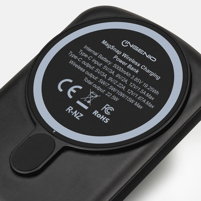 A black wireless charging power bank with a circular charging pad and a logo on the surface.