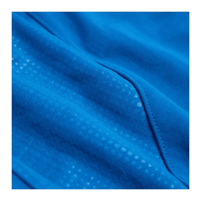 A close-up of a bright blue fabric with a textured pattern, featuring seams and details from a full zip jacket.
