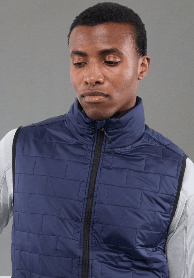 A navy lightweight packable insulated puffer vest on a model, featuring a high collar and zip closure.