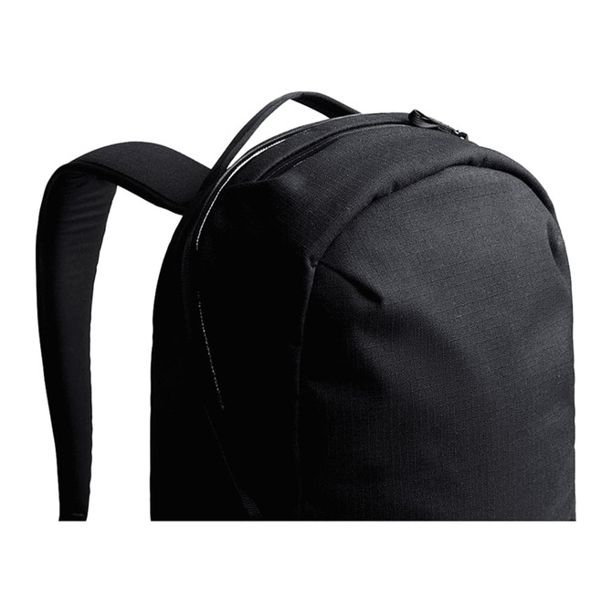 A black backpack with smooth fabric and padded straps, featuring a zippered compartment at the top.