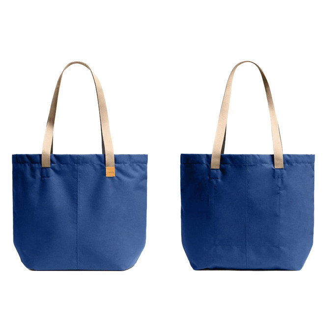 A blue tote bag with beige straps, featuring a simple design and a logo on the front.