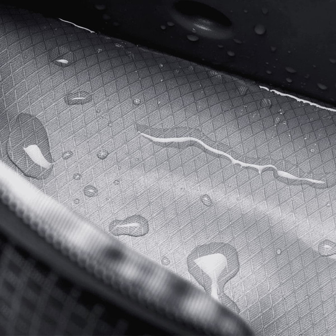 A grey interior of a cooler bag features a textured surface with visible water droplets. It has a logo.