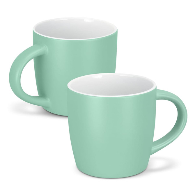 A drinkware set featuring two mint green coffee mugs with white interiors and round handles. One mug is slightly behind the other.