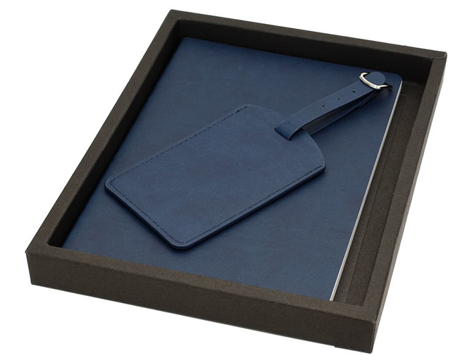 A blue travel journal set with a matching luggage tag, presented in a sleek black box.