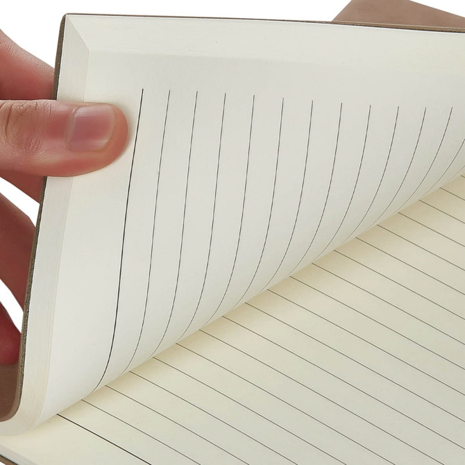 A hand holds a brown Falby notebook with lined, cream-coloured pages. It features a simple design and a logo.