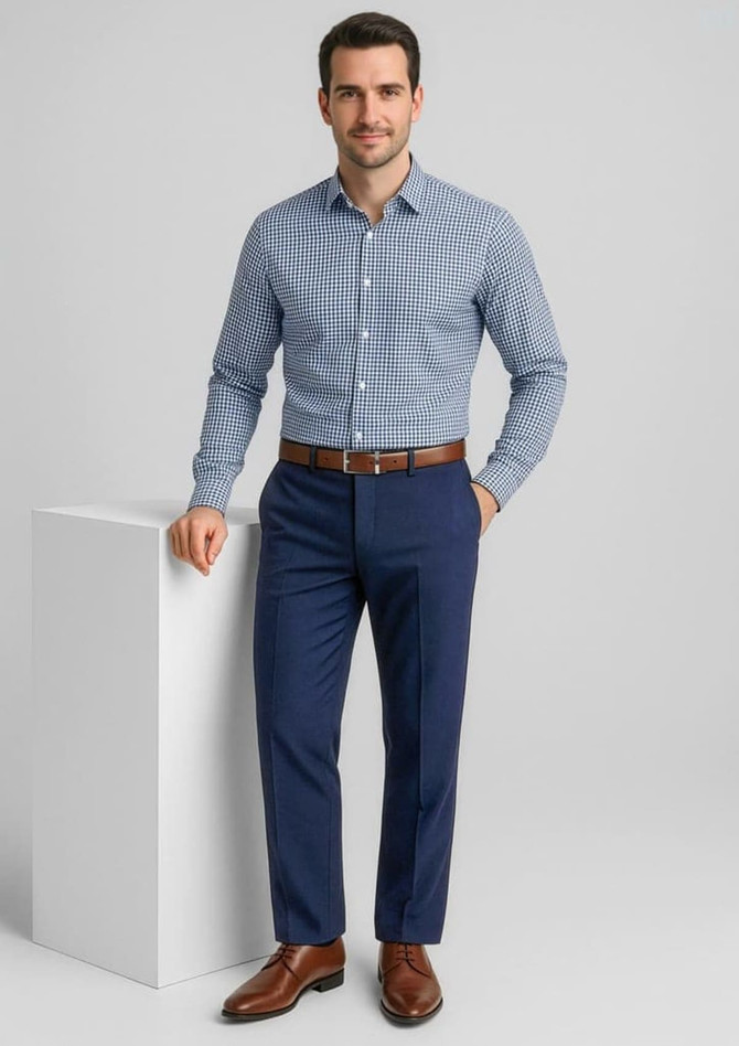 A man in a checkered shirt and brown belt poses in navy slacks, showcasing a sophisticated look.
