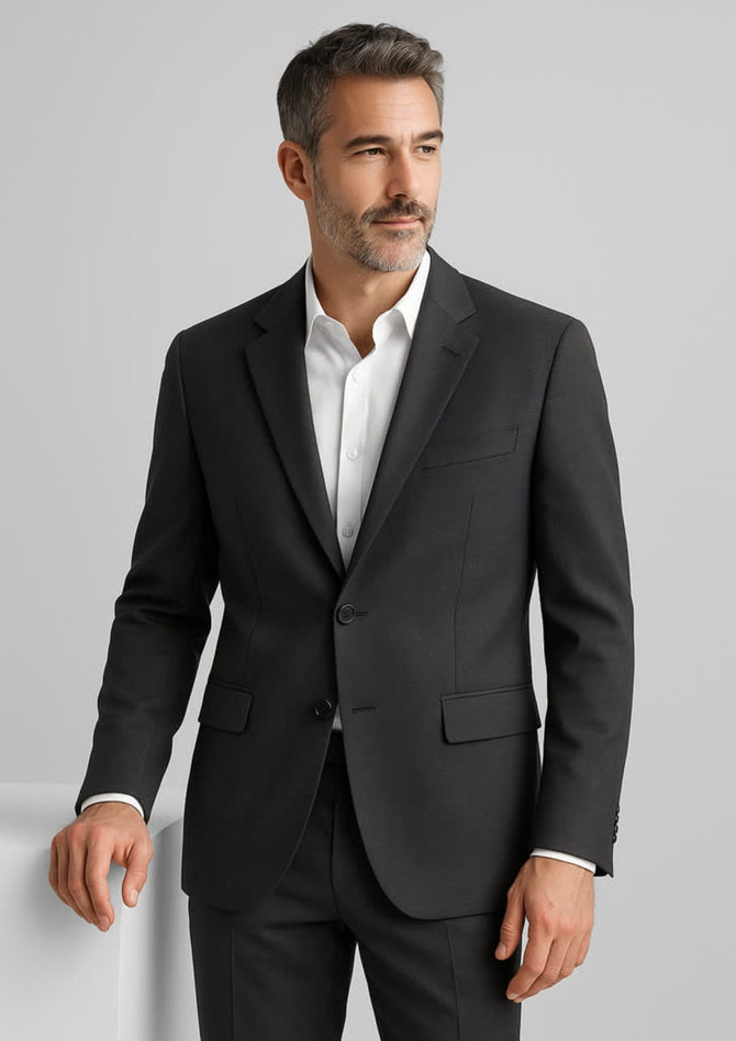 A man in a dark grey wool stretch blazer, featuring a two-button front and a classic fit, stands confidently.