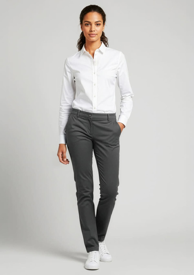 A woman is wearing grey Women's Lawson Chino Pants paired with a white shirt and white shoes. The image features a logo.