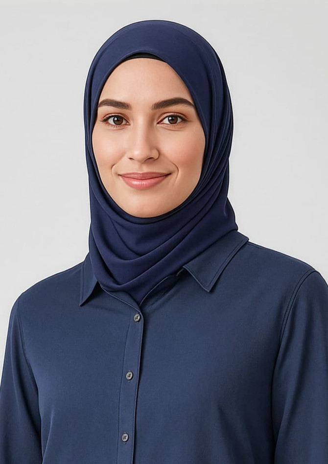 A navy blue hijab worn by a woman, complemented by a button-up shirt. The image features a logo.