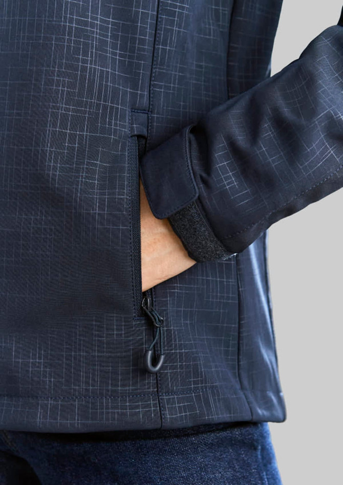 A soft shell jacket in navy with a geometric pattern and a zippered pocket. Features a snug cuff detail.