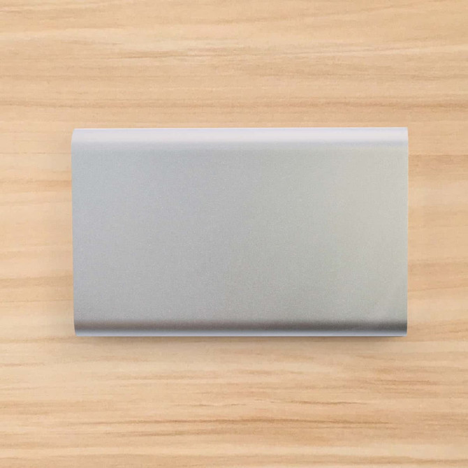 A sleek silver power bank with an 8,000mAh capacity.