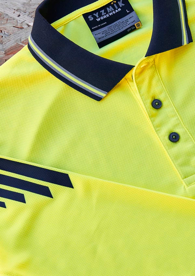 A yellow long sleeve polo featuring black stripes and a collar, with a brand label on the inside.