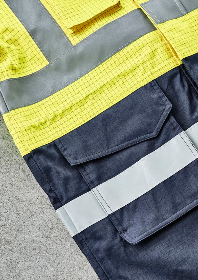 A bright yellow and dark navy jacket featuring reflective strips and multiple pockets, with a logo present.