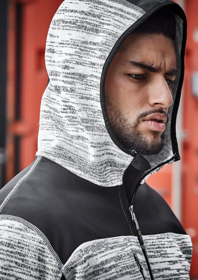 A unisex reinforced knit hoodie in black and grey, featuring a hood and a zip closure, displayed on a model.