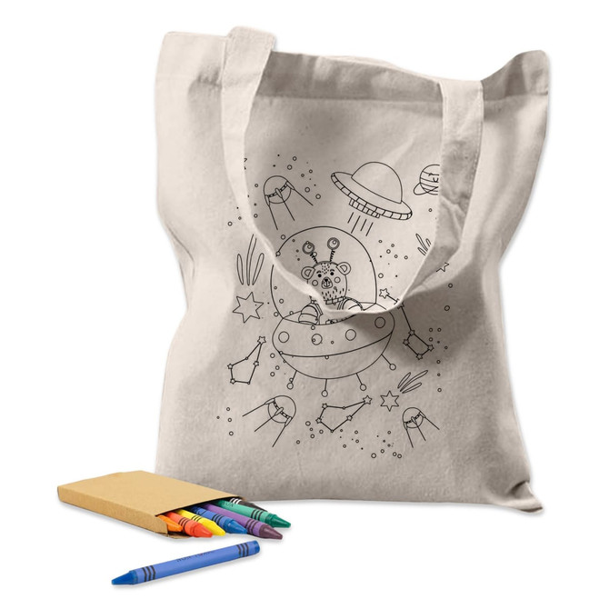 A cream-coloured tote bag featuring a line drawing of a spaceship and aliens, accompanied by colourful crayons.