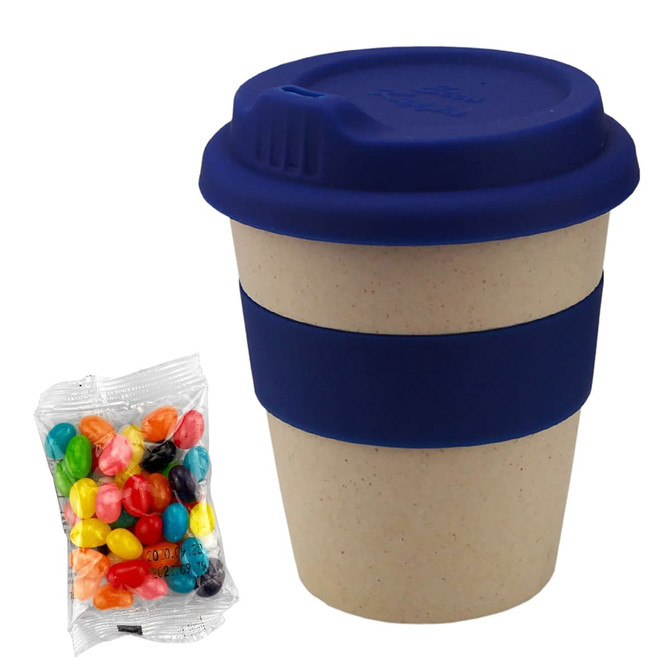 A bamboo cup in natural colour with a blue silicon lid and band, alongside a bag of multi-coloured jelly beans.