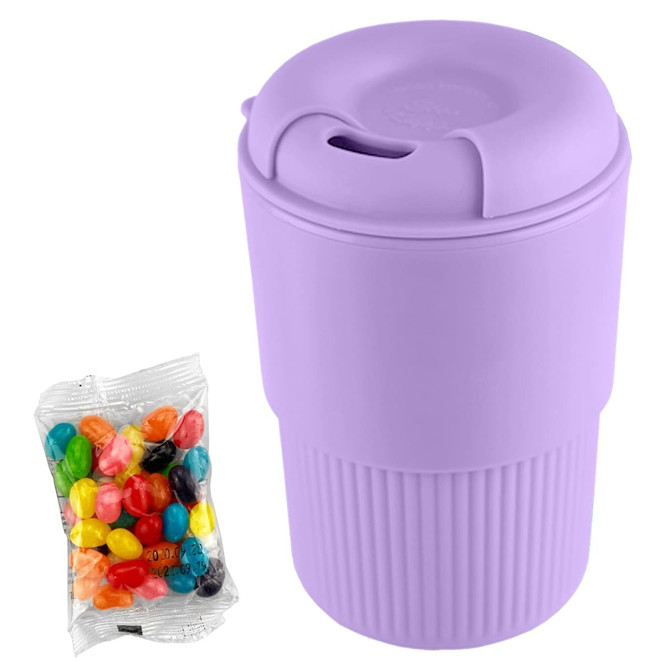 A purple reusable coffee cup with a textured grip, alongside a pack of colourful jelly beans.