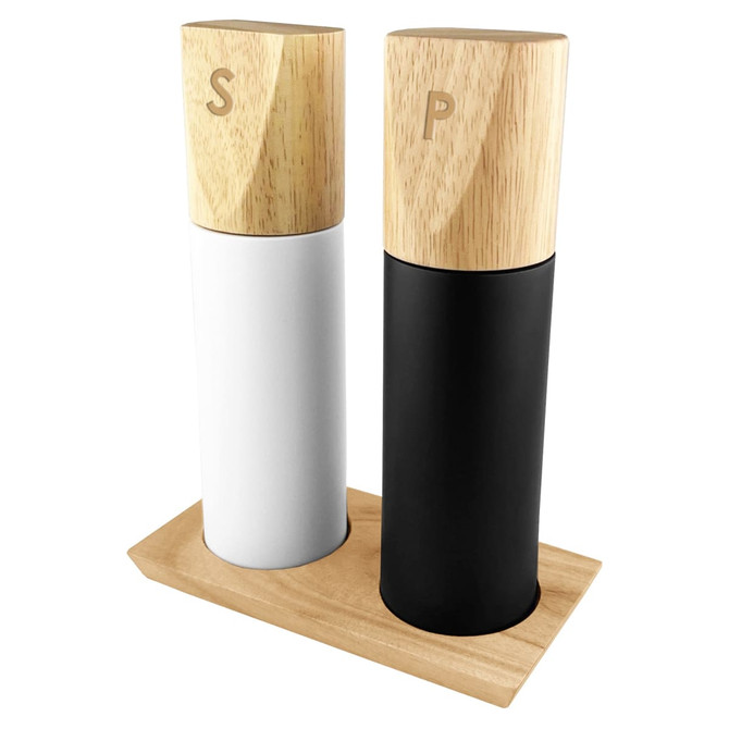 A salt and pepper grinder set with white and black ceramic bodies and wooden tops, displayed on a wooden base.