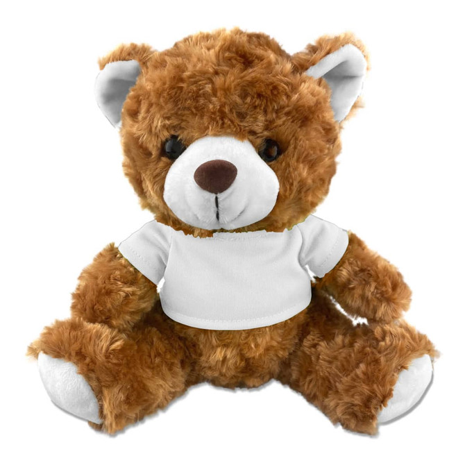 A plush teddy bear in a soft brown colour, wearing a plain white t-shirt, with black button-like eyes.