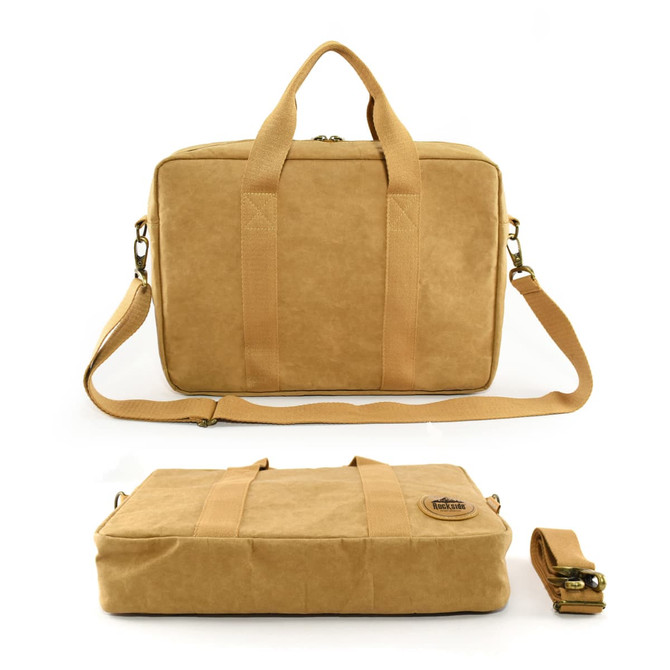 A tan satchel with dual handles, a detachable strap, and a logo, featuring a smooth, textured surface.