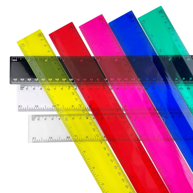 A collection of plastic rulers in various colours, including yellow, pink, blue, clear, and black, with measurement markings.