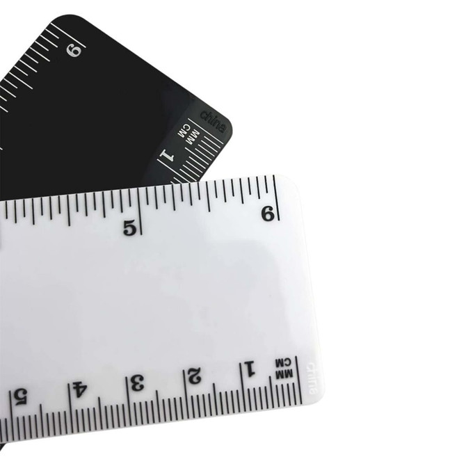 A plastic ruler set featuring a 15cm white ruler with black markings and a black ruler with white markings.