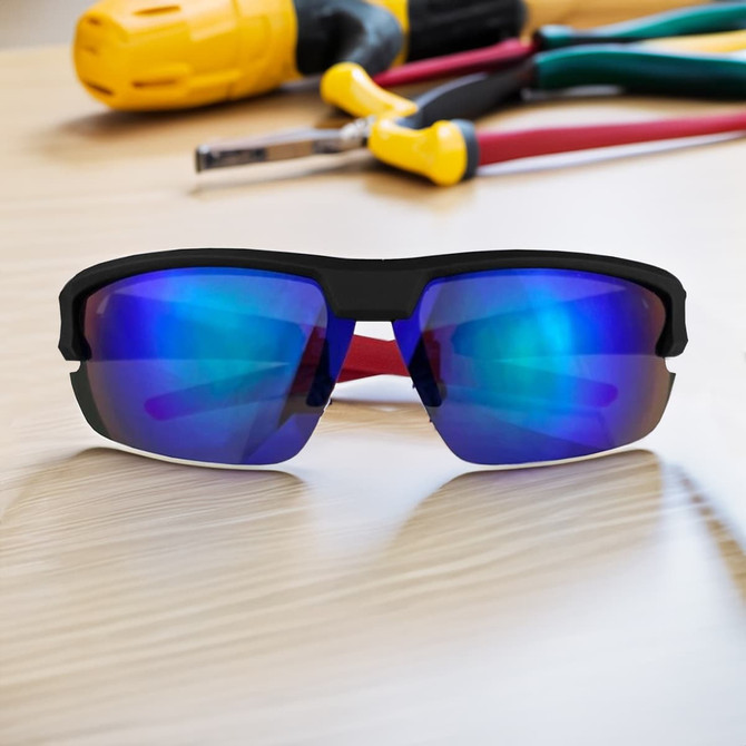 Sporty black sunglasses with blue reflective lenses, positioned on a wooden surface near tools. Features a logo.