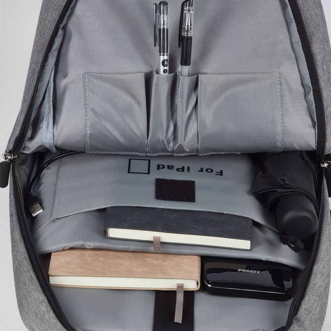 A grey Techpac Laptop Backpack with compartments for pens, a notebook, a charger, and an umbrella inside.