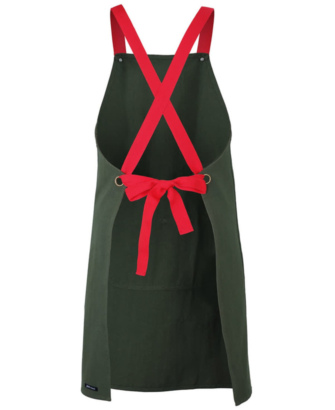 A green canvas apron with red cross-back straps and a tied bow at the waist. It features a logo.