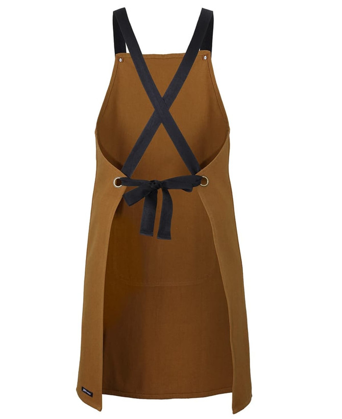 A brown cross-back canvas apron with black straps and a tied waist, featuring a logo.