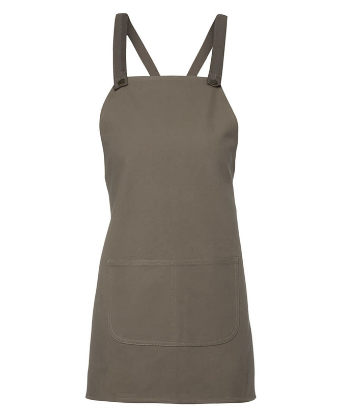 A khaki green canvas bib apron featuring cross back straps and a front pocket. It has a brand logo.
