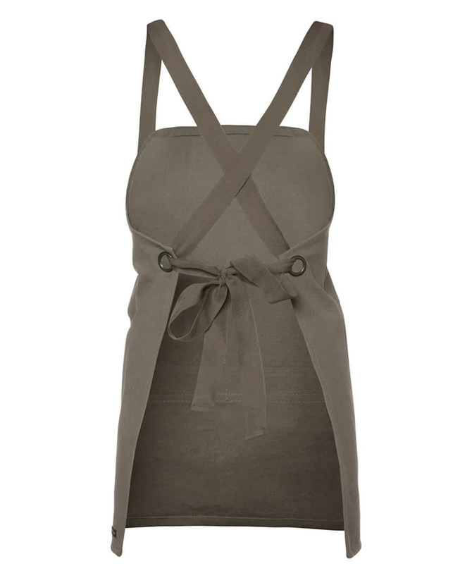 A khaki canvas bib apron with crossback straps and a tied waist, featuring a logo. 