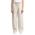 Linen pants in a light beige colour, featuring a drawstring waistband and wide-leg design.
