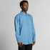 A blue denim button-up shirt with a pocket, featuring long sleeves and a collar. The shirt has a logo on it.