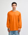 An orange heavyweight cotton unisex long sleeve t-shirt displayed on a model, featuring a logo.