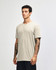 A unisex henley T-shirt in beige, featuring a round neckline and short sleeves, displayed on a model.