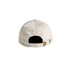 A light beige cap with a back strap and a logo. The design is simple and unstructured.
