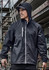 A unisex super light packable rain jacket in black, featuring a hood and zippered pocket, against a construction backdrop.